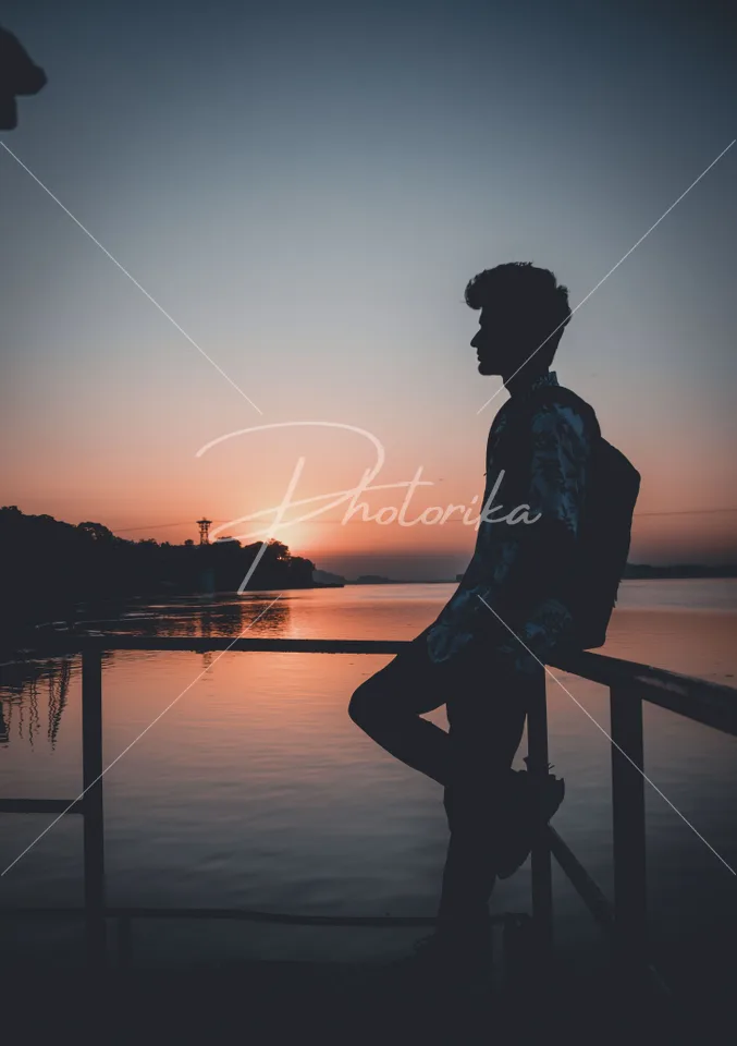 man-alone-riverside-sunset