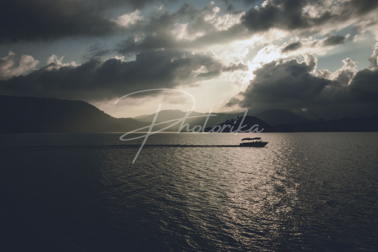 boat-on-lake-sunset-clouds