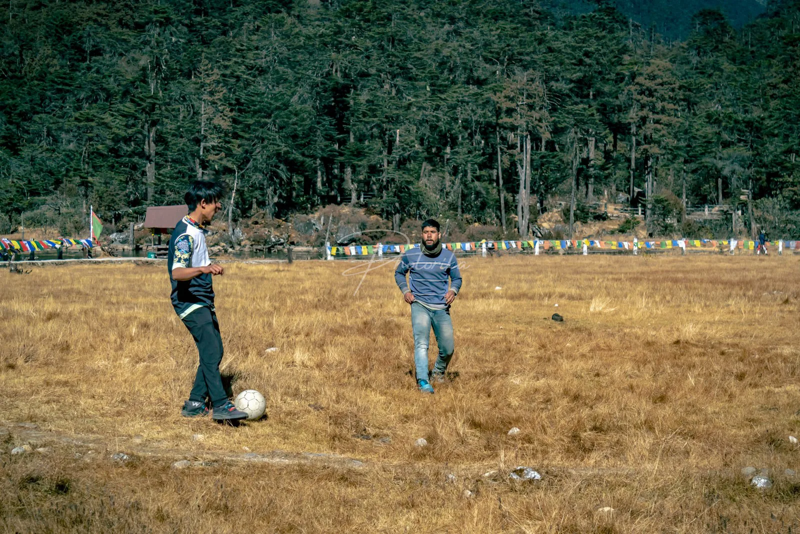 men-playing-football-soccer-in-village-area