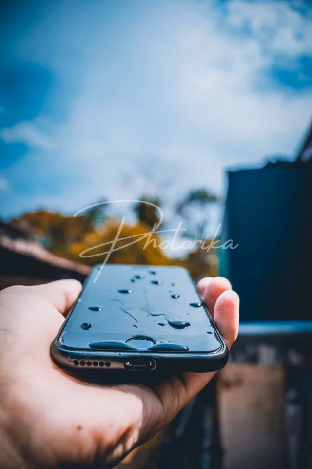 hand-holding-phone-water-drops