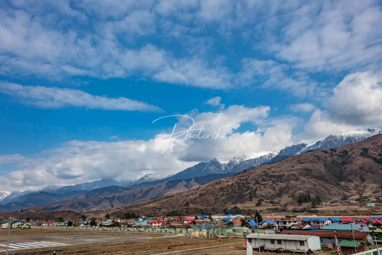 town-surrounded-by-mountains-blue-sky