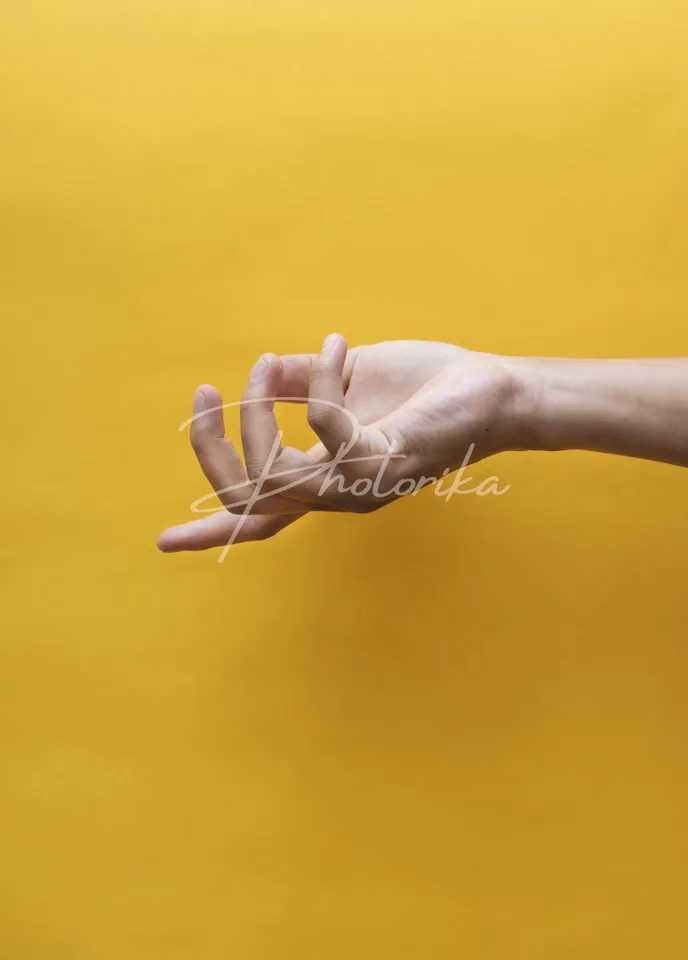 man-hand-yellow-background