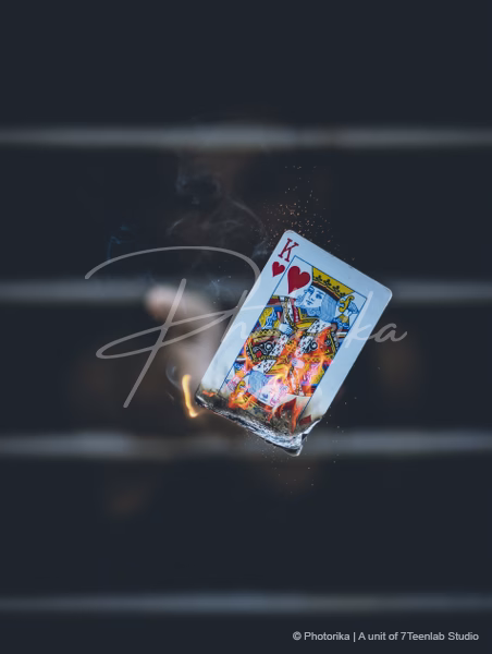 man-throwing-burning-kings-of-card