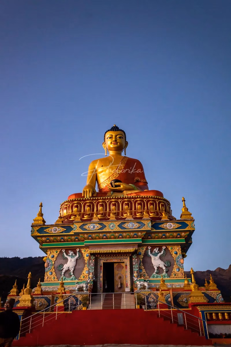 tall-standing-lord-buddha-statue-blue-sky