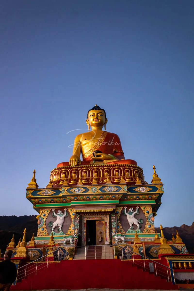 tall-standing-lord-buddha-statue-blue-sky